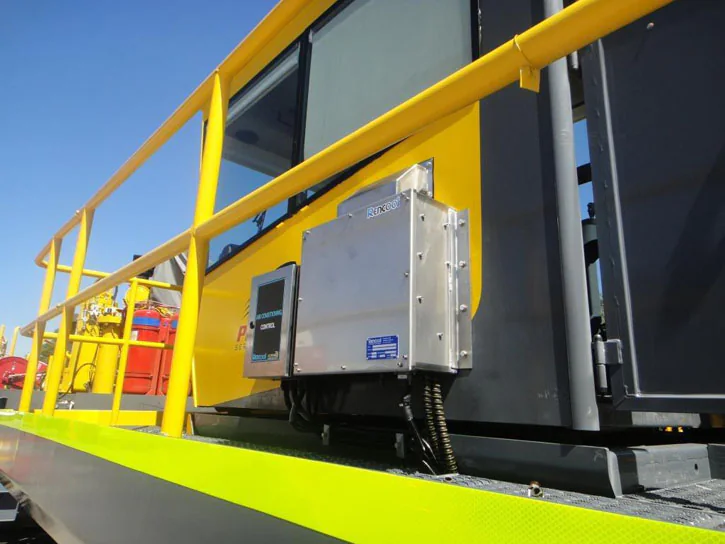 Air conditioning equipment mounted outside an industrial machinery cab.