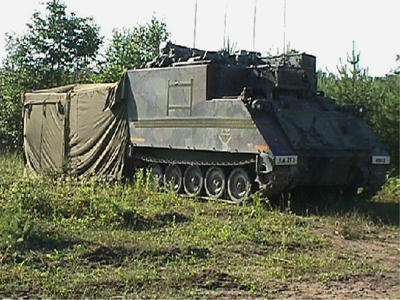 M577 command post carrier with an attached modular shelter.