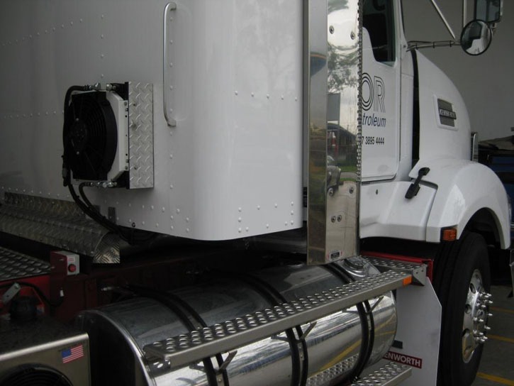 Cooling unit installed behind the sleeper cab of a Kenworth truck.